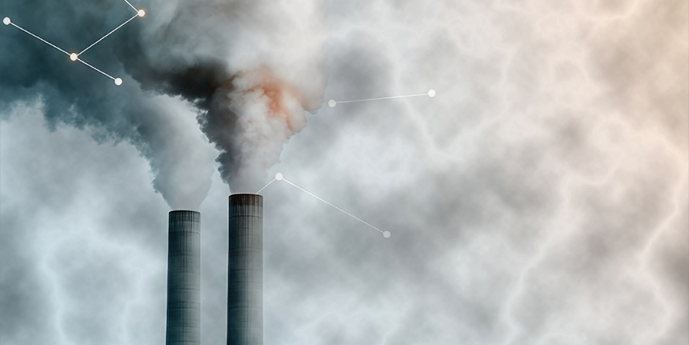 Industrial smokestacks release emissions into atmosphere, highlighting pollution challenges