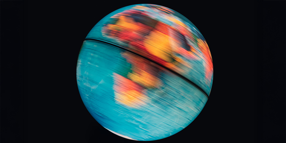 Illuminated world globe spinning with black background
